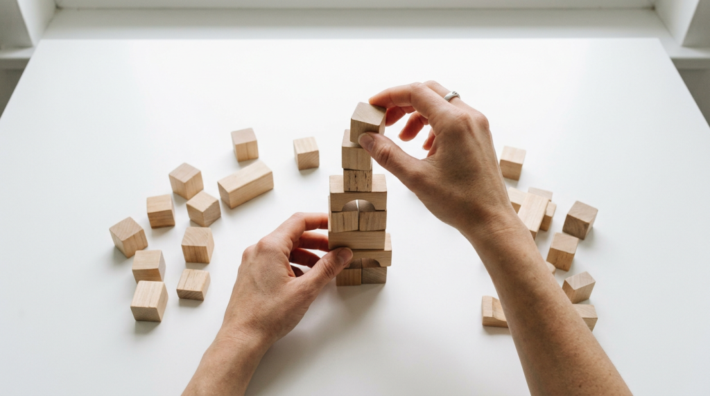The three engineering principles behind reliable AI-assisted product development 1 Wooden building blocks illustrating the small-steps principle in AI-assisted product development